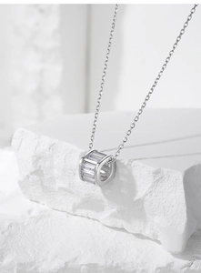 Macro view of S925 silver necklace with sparkling baguette-cut zircon cylinder pendant