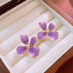 Elegant purple petal stud earrings with white pearl center in premium velvet jewelry box