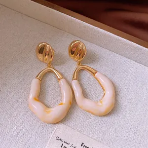Vintage irregular resin hoop earrings with golden ripple studs in French retro style