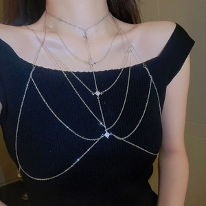Macro view of multi-layered silver body chain with sparkling square zircon accents