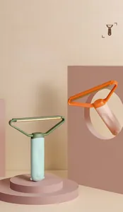 Close-up of dual-purpose lint scrapers in mint green and orange for pet hair cleaning