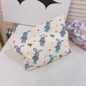 Detail of cute cotton cosmetic bag with blue rabbit print and simple wish label