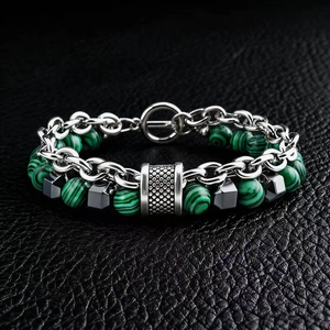 Detailed close-up of malachite beads and metallic links on a men's hip-hop bracelet