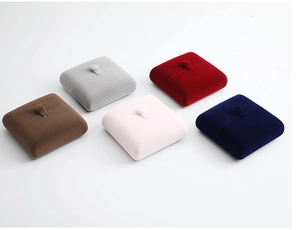 Close-up of five velvet jewelry boxes in various colors with elegant button detail