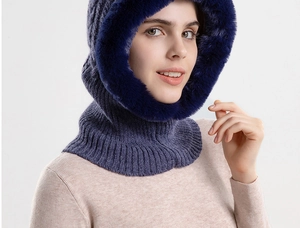 Detail of navy knit hood with fluffy faux fur trim showing thick thermal texture for winter