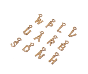 Detailed view of gold plated bamboo style alphabet pendants with small rings