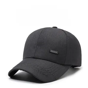 Close-up of charcoal grey baseball cap with FASHION label and mountain embroidery