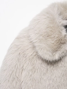 Close-up of fluffy faux fur texture and collar detail on light gray plush coat