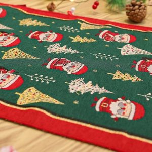 Detail of Christmas table runner with Santa Claus motifs and golden embroidery on wood