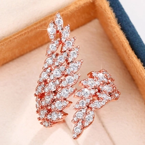 Macro detail of rose gold angel wing ring with shimmering pave-set cubic zirconia