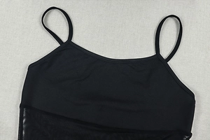 Detail of black dress strap and mesh splicing with fine sewing craftsmanship on grey fabric