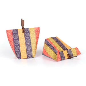 Colorful striped paper gift boxes with floral patterns and brown ribbon closure
