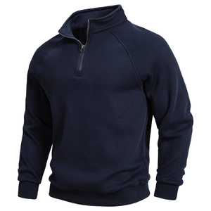 Detail of navy blue waffle knit texture on men's stand collar half-zip sweatshirt