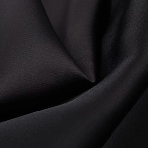 Close-up of black satin fabric showing fine texture, smooth sheen and elegant drape