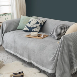 Grey waffle weave sofa blanket with white borders and stylish grey tassels decoration