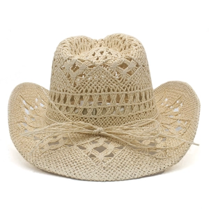 Close-up of hollow woven pattern and bow tie detail on a wide brim straw cowboy hat