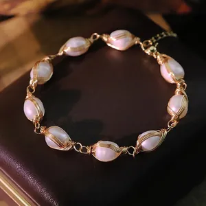 Handmade freshwater pearl bracelet with gold wire wrapping and adjustable buckle closure
