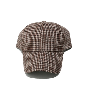 Close-up of brown houndstooth pattern and thick woven texture on baseball cap fabric