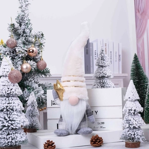 Nordic Christmas gnome plush with white hat and gold star standing on festive bookshelf