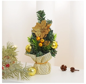 Close-up of a 20cm mini Christmas tree with golden flowers and ornaments for desk decor