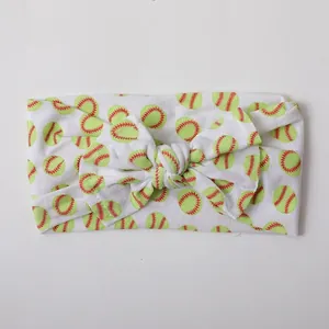 Detail of soft nylon baby headband with baseball print and large knotted bow feature