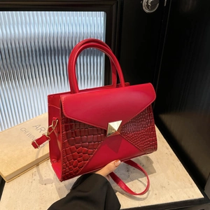 Red crocodile texture patchwork handbag with golden pyramid stud and round handle
