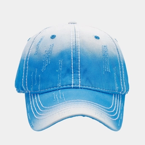 Close-up of blue gradient baseball cap featuring vintage distressed washed denim details