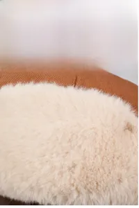 Macro detail of winter trapper hat with thick faux fur lining and windproof brown cotton fabric