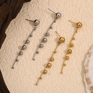 Minimalist stainless steel ball tassel earrings in gold and silver finish on textured base