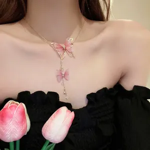 Pink tulle butterfly fringe necklace with rhinestones and gold chain on model