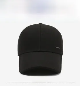 Close-up of black baseball cap showing durable cotton fabric and silver metal logo detail