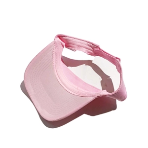 Detailed top view of a pink athletic sun visor hat for women with adjustable strap buckle