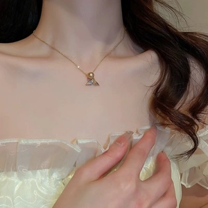 Elegant gold titanium steel necklace featuring a fishtail pendant with a single pearl
