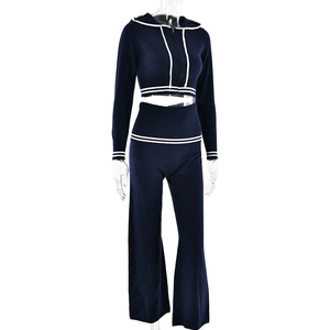 Navy knit tracksuit set featuring white stripes on cuffs and hem on a mannequin