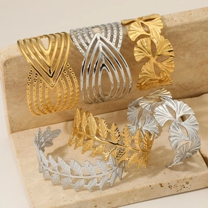 Hollow geometric and leaf patterned open cuff bracelet set in gold and silver finish