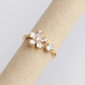 Macro shot of gold floral adjustable ring with clear teardrop zirconia petals