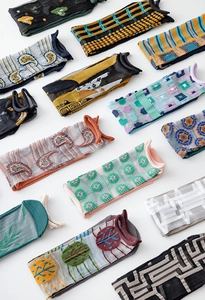 Flat lay of women's sheer mesh crew socks with mixed patterns and colorful designs