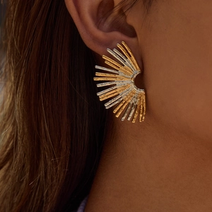 Two-tone radiating fan-shaped earrings in gold and silver finish on a model