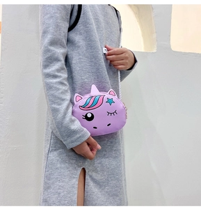 Detail view of a purple unicorn crossbody bag for girls with a white woven strap