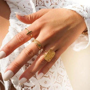 Gold plated snake rings with green zircon and rectangle signet ring on model hand