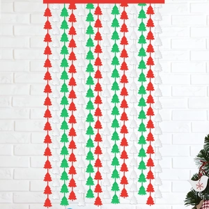 Festive red, green, and white Christmas tree fringe curtain hanging on a white wall decor