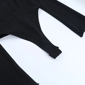 Detail view of the snap-button closure and knit fabric on a black long sleeve bodysuit