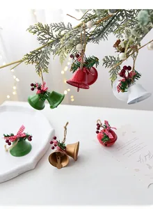 Close-up of colorful Christmas metal bells with pine needles and plaid bows decorations