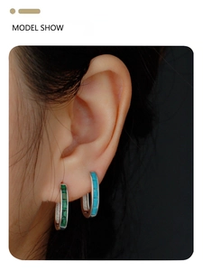 Model wearing s925 silver emerald and turquoise square gemstone huggie hoop earrings