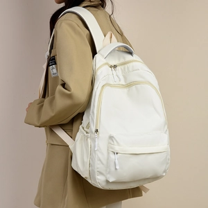 Minimalist white large capacity nylon backpack with multiple zipper compartments for women