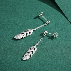 Elegant S925 sterling silver feather drop earrings on a dark green textured background