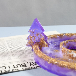 Detailed close-up of handmade resin tray with purple swirls and gold foil accents