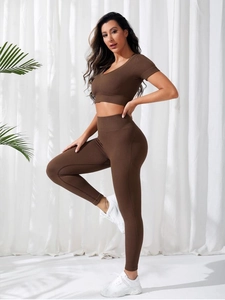 Detailed close-up of dark coffee ribbed knit fabric on a slim fit yoga set