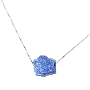 Minimalist silver chain necklace featuring a large irregular raw blue crystal stone pendant