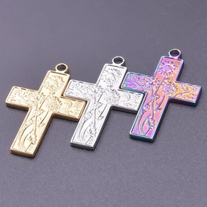 Detailed view of 18k plated stainless steel cross pendants with sunflower engraving